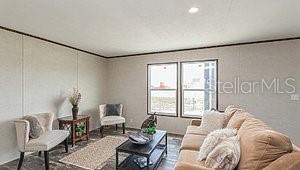 living area with ornamental molding