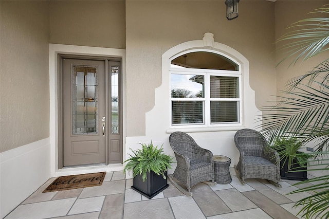 view of exterior entry featuring stucco siding