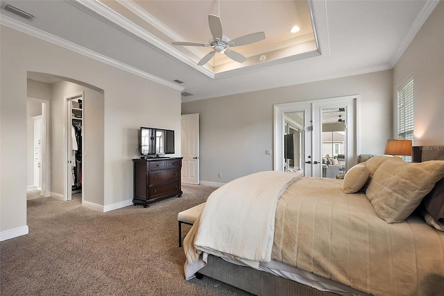 bedroom featuring visible vents, arched walkways, carpet flooring, and ornamental molding