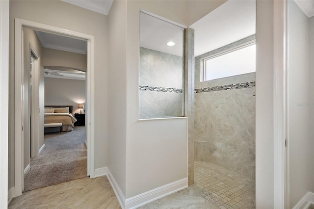 ensuite bathroom featuring a ceiling fan, baseboards, walk in shower, and connected bathroom