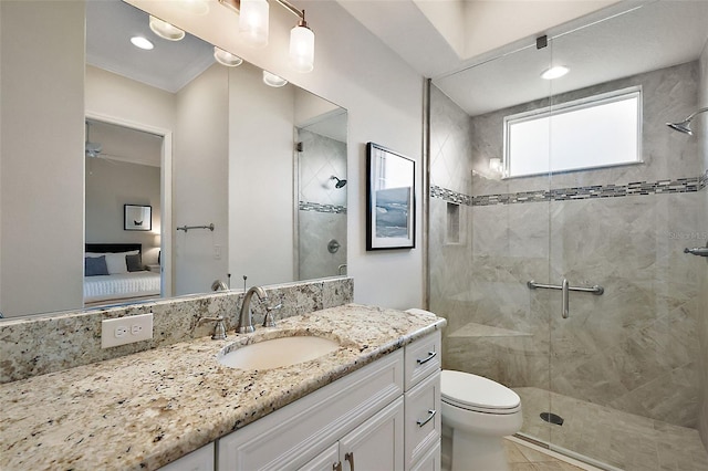 bathroom featuring connected bathroom, a shower stall, toilet, and vanity