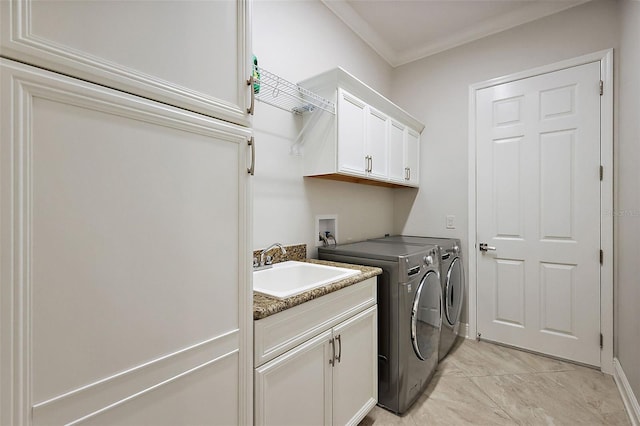 laundry area with a sink, cabinet space, crown molding, and washer and dryer