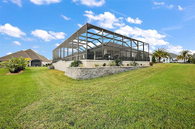 rear view of property featuring a lawn and a lanai