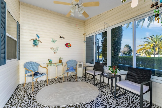 sunroom featuring a ceiling fan