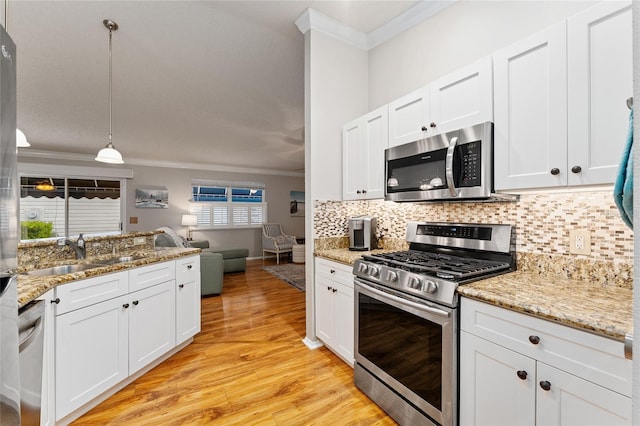 kitchen featuring a sink, ornamental molding, backsplash, and stainless steel appliances