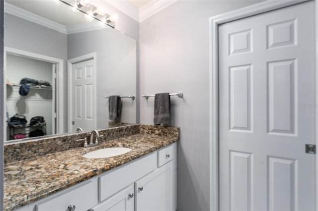 bathroom with vanity and ornamental molding