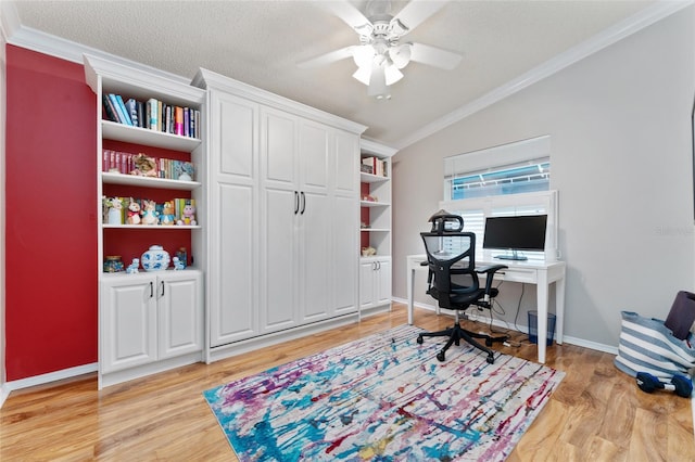 home office featuring vaulted ceiling, crown molding, light wood finished floors, and a textured ceiling