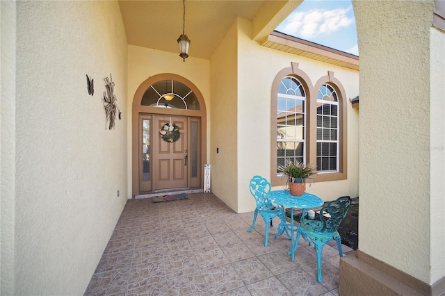 property entrance featuring stucco siding