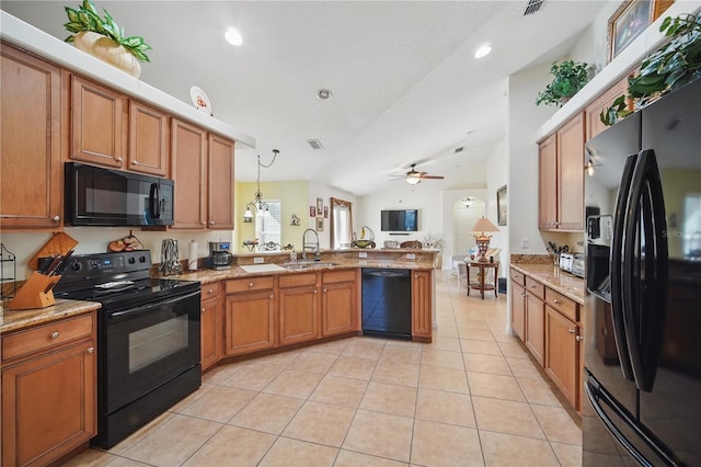 kitchen with light tile patterned flooring, a peninsula, a sink, brown cabinets, and black appliances