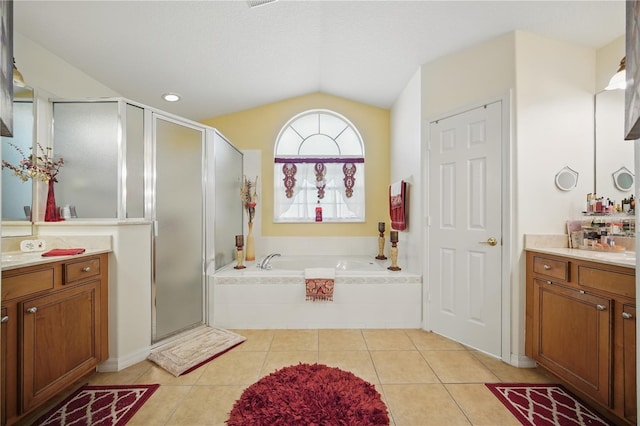 full bath with a garden tub, vaulted ceiling, vanity, a shower stall, and tile patterned flooring