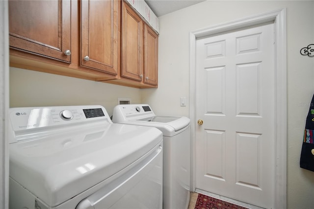 laundry room with cabinet space and washer and clothes dryer