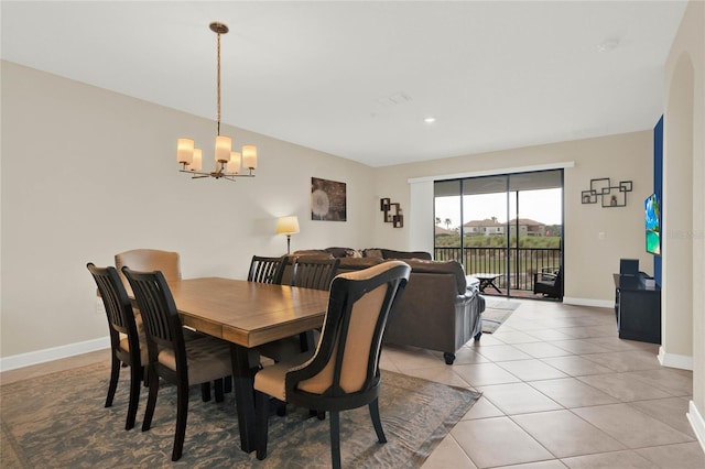 dining room featuring light tile patterned floors, baseboards, and a chandelier