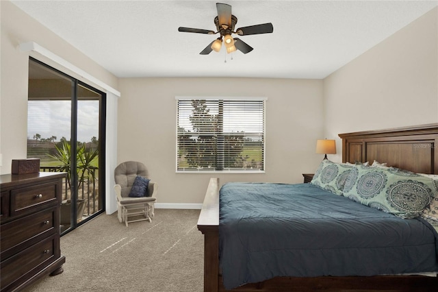 bedroom with baseboards, access to outside, multiple windows, and light colored carpet