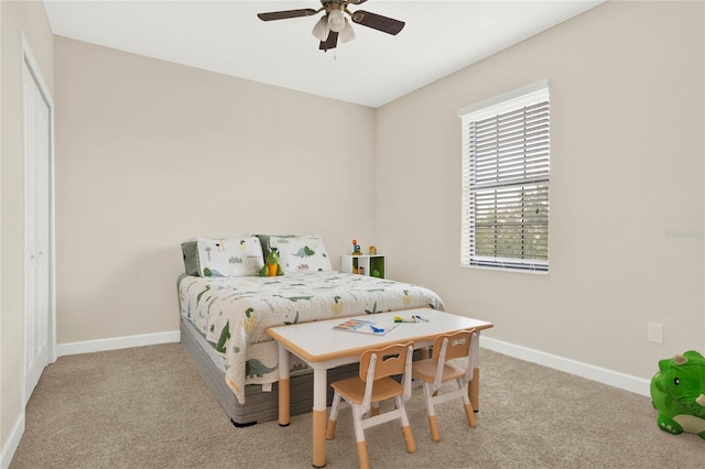 bedroom with baseboards, a ceiling fan, and light colored carpet