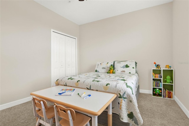 bedroom with carpet floors, baseboards, and a closet