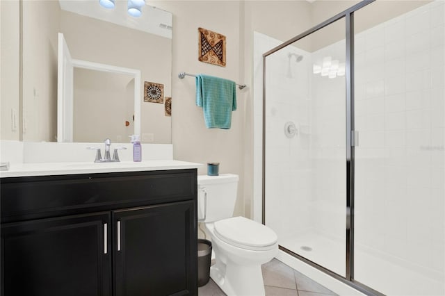 bathroom with vanity, tile patterned flooring, a shower stall, and toilet