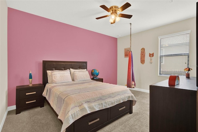 bedroom with a ceiling fan, light colored carpet, and baseboards