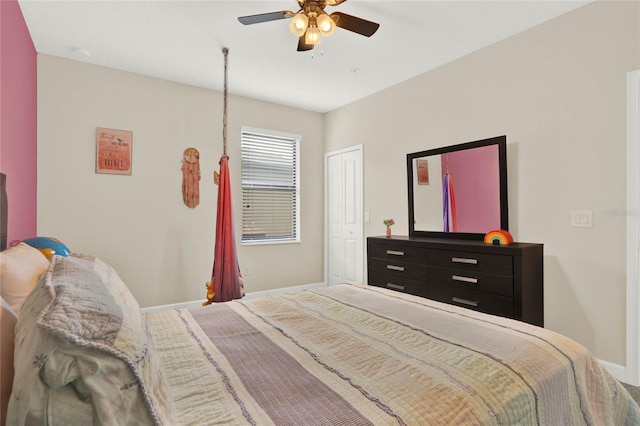 bedroom featuring a closet, baseboards, and a ceiling fan