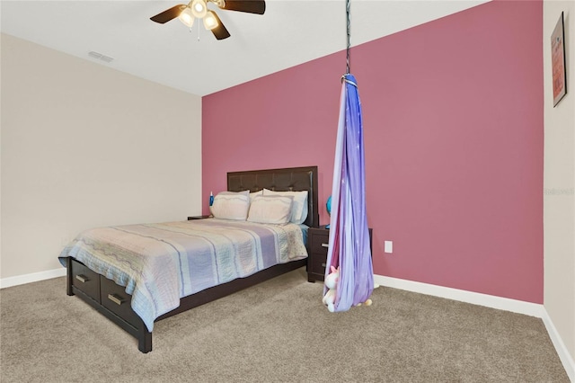 carpeted bedroom featuring baseboards, visible vents, and a ceiling fan