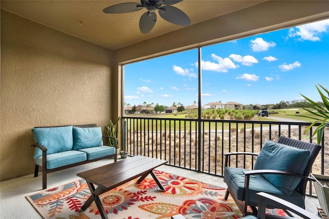 sunroom featuring ceiling fan