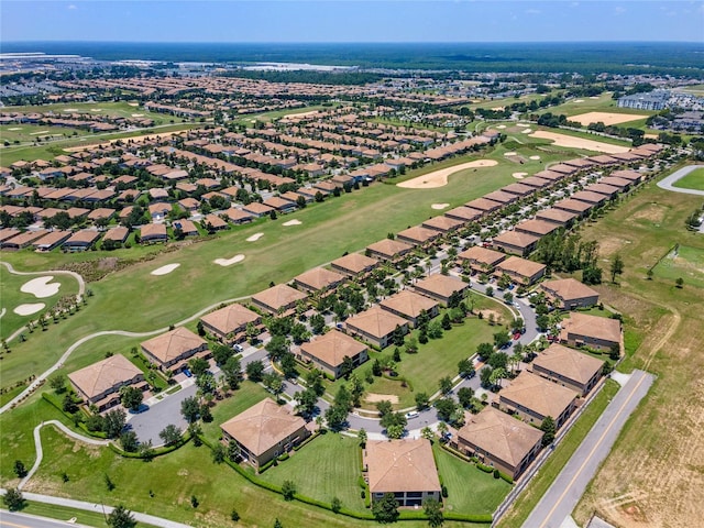 birds eye view of property featuring view of golf course and a residential view