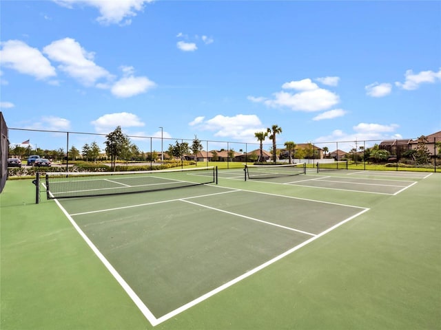 view of tennis court featuring fence