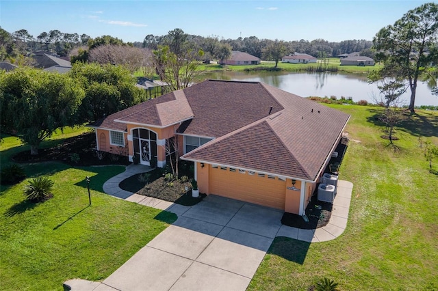 birds eye view of property with a water view