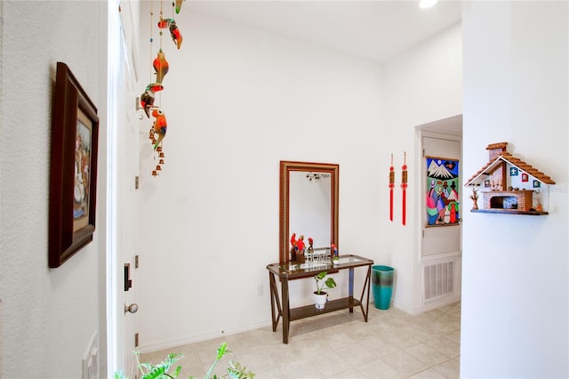 hallway with visible vents and baseboards