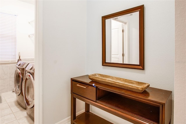 interior space with light tile patterned floors, laundry area, and washer and dryer