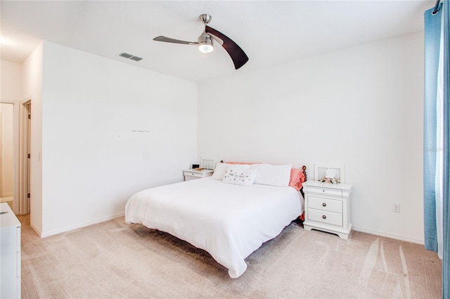 bedroom featuring visible vents, baseboards, light colored carpet, and ceiling fan