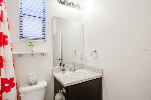 full bath featuring toilet and vanity