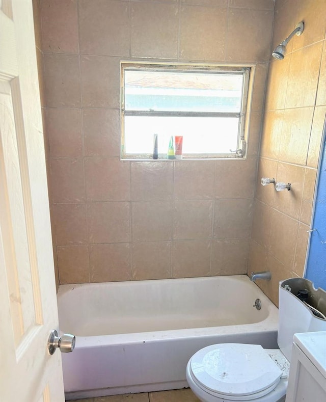 bathroom featuring shower / bathtub combination and toilet