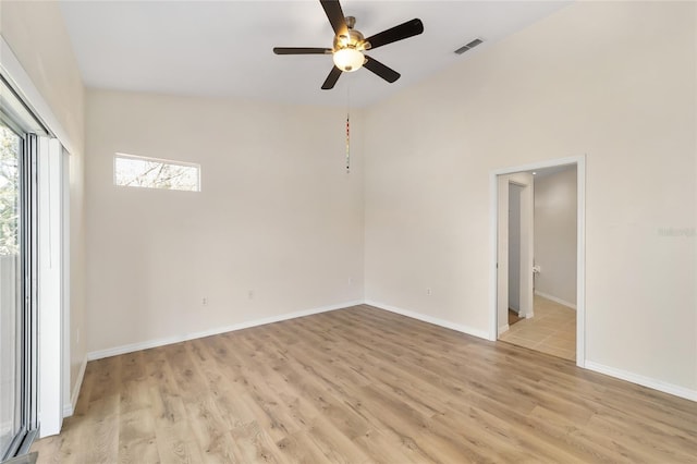 empty room with light wood-type flooring, baseboards, visible vents, and a ceiling fan