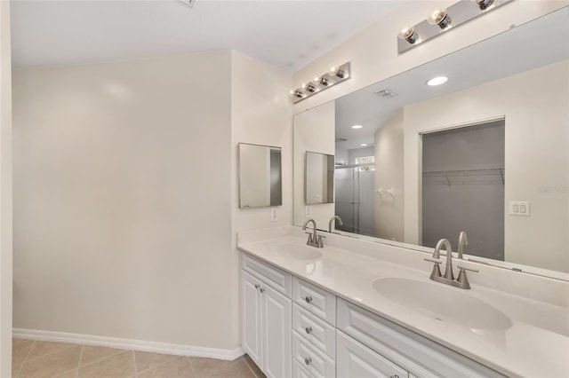 full bath featuring visible vents, a sink, baseboards, and double vanity