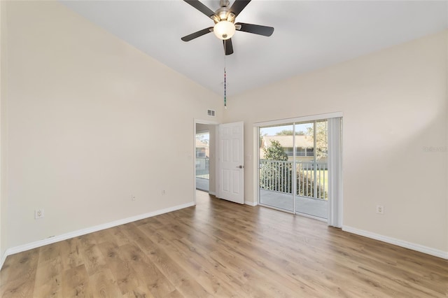 unfurnished room with lofted ceiling, visible vents, light wood-style flooring, and baseboards