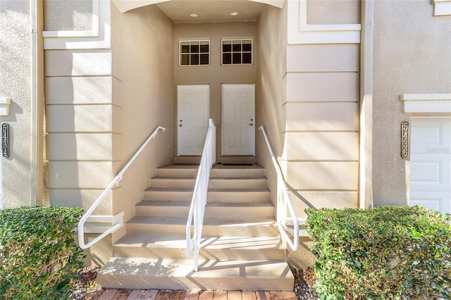 entrance to property featuring stucco siding