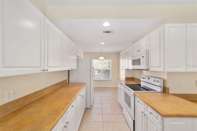 kitchen with white appliances, visible vents, light tile patterned flooring, white cabinetry, and recessed lighting