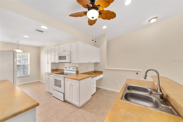 kitchen featuring visible vents, light tile patterned flooring, a sink, white cabinetry, and white appliances