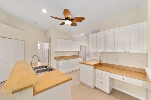 kitchen featuring a ceiling fan, white cabinets, a sink, and recessed lighting