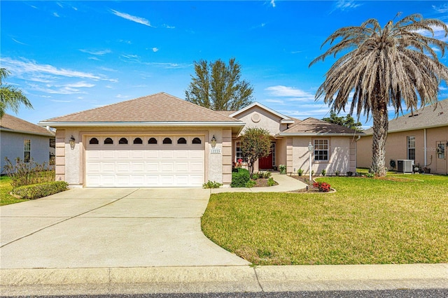 single story home featuring central air condition unit, a garage, concrete driveway, stucco siding, and a front yard