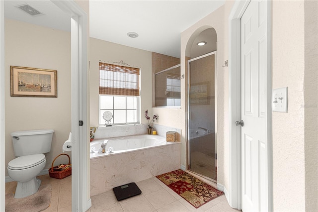 bathroom with a bath, toilet, a stall shower, and visible vents