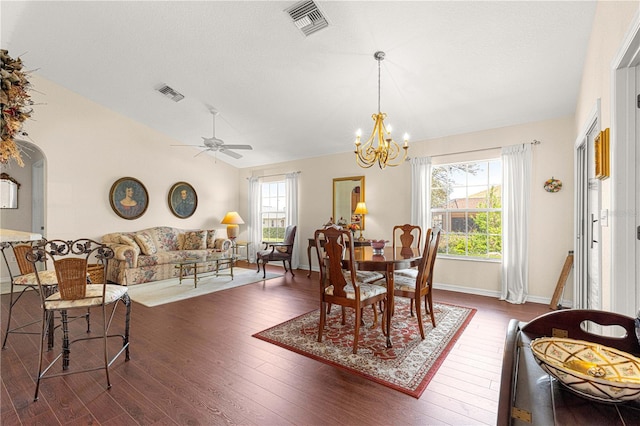 dining room featuring lofted ceiling, dark wood-style flooring, visible vents, and baseboards