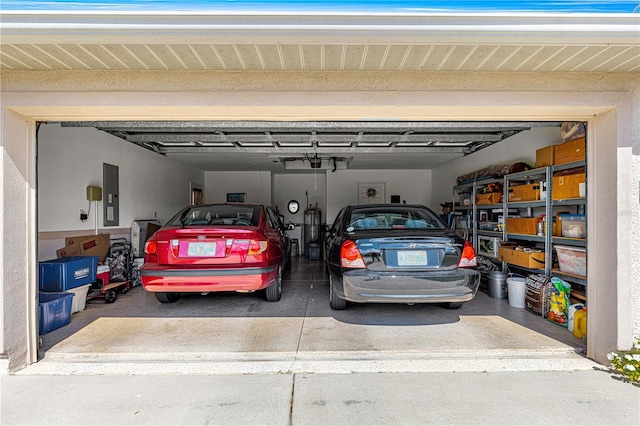 garage featuring concrete driveway and electric panel