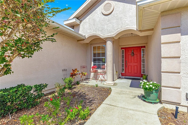 property entrance featuring stucco siding