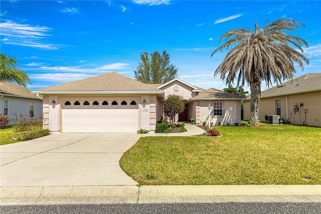 single story home featuring stucco siding, central air condition unit, concrete driveway, an attached garage, and a front yard