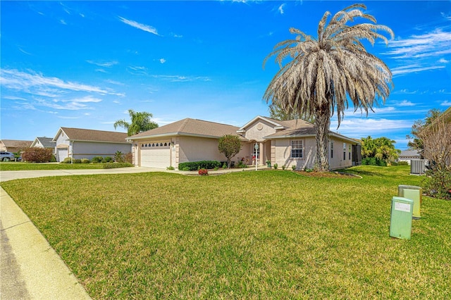 single story home with stucco siding, concrete driveway, an attached garage, central AC unit, and a front yard