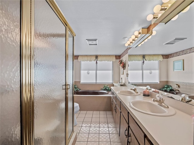 bathroom featuring a bath, visible vents, a sink, and tile patterned floors