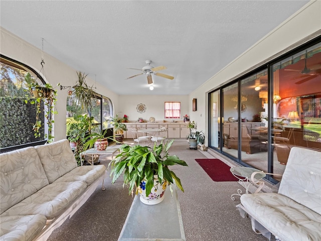 sunroom featuring a ceiling fan