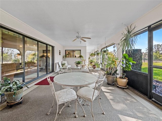 sunroom featuring ceiling fan