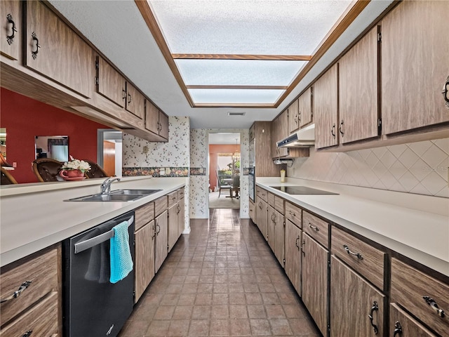 kitchen featuring wallpapered walls, dishwasher, black electric stovetop, under cabinet range hood, and a sink